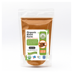 Close-up of organic cinnamon powder in a glass jar with farm background, highlighting natural and fresh quality