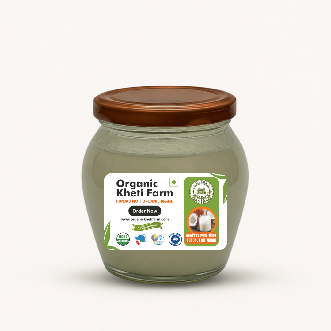 Bottle of organic cold pressed virgin coconut oil with fresh coconuts from Punjab farm