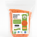 Close-up of organic red Masoor Mogar Dal from Punjab, showing unpolished, vibrant red lentils in a bowl