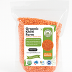 Close-up of organic red Masoor Mogar Dal from Punjab, showing unpolished, vibrant red lentils in a bowl