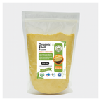 Yellow organic corn flour in a traditional Punjabi kitchen setting, highlighting farm-fresh quality and natural ingredients.